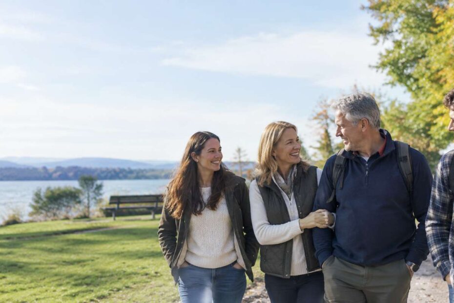 Mature couple enjoying a relaxed outdoor walk while navigating dating after 50 with adult children